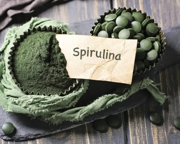 Proszek i tabletki spiruliny, naturalny sposób na wzmocnienie włosów.